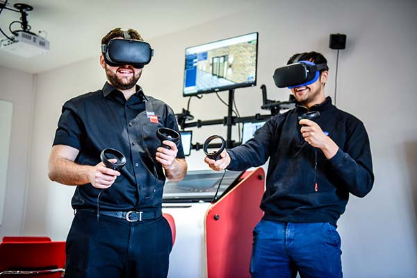 A picture of two DriveWorks team members wearing VR headsets.