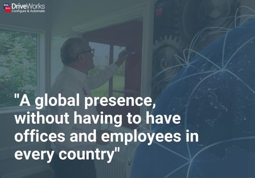 A picture of DriveWorks CEO, Glen Smith, working in an office with a globe and text: global presence, without having to have office and employees in every country